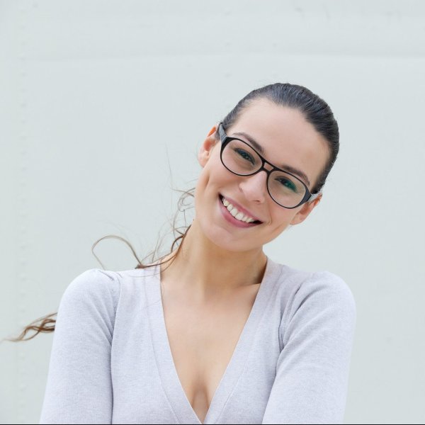 attractive young woman smiling with glasses e1612949530859